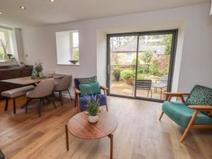 a living room with a table and chairs at Snowdrop Cottage in Morpeth