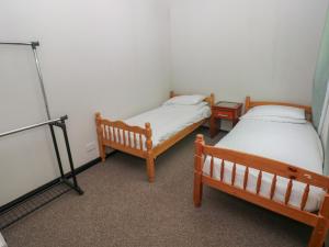 a room with two beds in a room at Cabin No 16 - Salt and Fern Cabins in Port Talbot