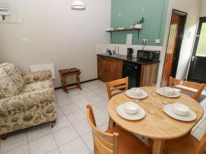 a living room with a table and a couch at Cabin No 15 - Salt and Fern Cabins in Port Talbot +14 photos