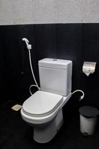a white toilet in a bathroom with a hose at Heavens Gate Ella in Ella +104 photos