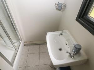 a bathroom with a toilet and a sink at Cabin No 15 - Salt and Fern Cabins in Port Talbot