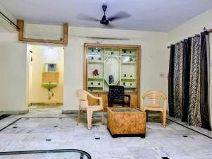 a living room with chairs and a table at Ravuri's Residency in Hyderabad