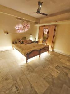 a bedroom with a bed and a large window at Ravuri's Residency in Hyderabad