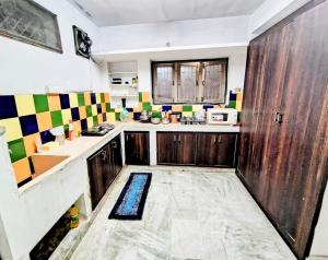 a kitchen with wooden cabinets and a counter top at Ravuri's Residency in Hyderabad
