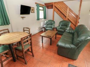 a living room with a couch and chairs and a table at Cabin No 11 - Salt and Fern Cabins in Port Talbot