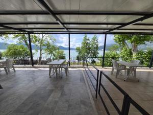a patio with tables and chairs and a view of the water at GÖL PENSION Adult Only 16 Plus in Egirdir