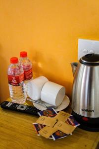 a counter with a coffee maker and a tea kettle at Heavens Gate Ella in Ella