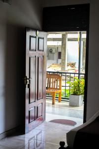 an open door in a room with a balcony at Heavens Gate Ella in Ella