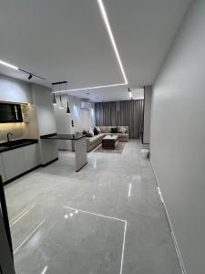 a living room with a couch and a table at Hodoon Apartments in Amman