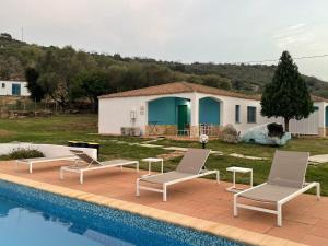 a group of chairs sitting next to a swimming pool at Hotel Baia Cea in Bari Sardo