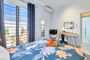 a bedroom with a bed with an orange stuffed animal on it at The Skyline Lookout Pool, BBQ, FREE parking in Stuart Park +21 photos