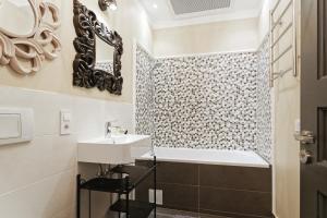 a bathroom with a sink and a bath tub at Riga Old Town Jāņa Sēta Residence in Rīga +60 photos