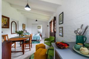 a kitchen and living room with a table and chairs at Disselblom Cottage in Sedgefield +15 photos