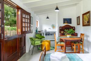 a room with a table and chairs and a kitchen at Disselblom Cottage in Sedgefield