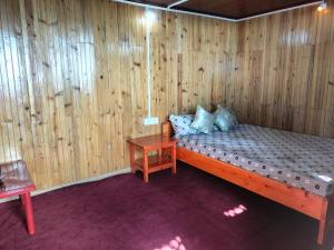 a room with a bed in a wooden wall at Dobhanay Homestay in Simāna Basti +17 photos
