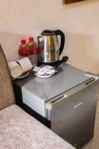 a counter with a tea kettle on top of a appliance at Heavens Gate Ella in Ella