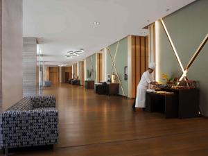 a man in a robe standing in a lobby at Novotel New Delhi Aerocity in New Delhi +163 photos