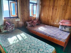 a small room with a bed and a couch at Dobhanay Homestay in Simāna Basti
