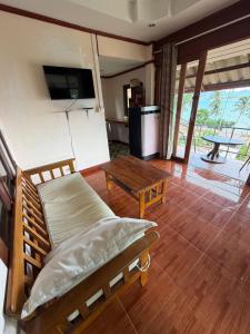 a living room with a couch and a table at Leam Sai Seaview in Ban Laem Sai