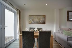 a dining room with a table and a couch at The Chislehurst Hideaway in Chislehurst