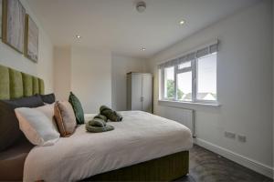 a bedroom with a large bed and a window at The Chislehurst Hideaway in Chislehurst