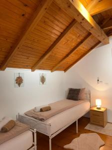 a bedroom with two beds and a wooden ceiling at Villa Solis Sarajevo Private Pool Jacuzzi in Sarajevo +56 photos