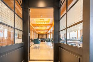 an open hallway with tables and chairs in a building at Summit Mall Stone Hotel at Mall Road in Darjeeling +16 photos