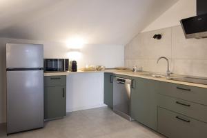 a kitchen with a refrigerator and a sink at Antares b&b in Cassina deʼ Pecchi