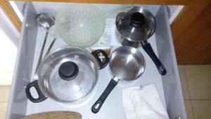 a bunch of kitchen utensils sitting on a shelf at Casa Lola in Agaete