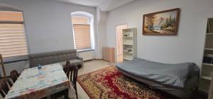 a room with a bed and a table in it at Residence APOLLO MJ z dwoma pokojami in Ząbkowice Śląskie