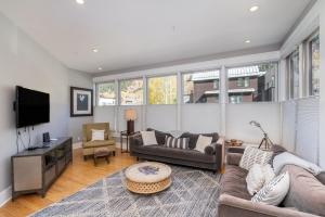 a living room with a couch and a tv at East Side Hideaway in Telluride