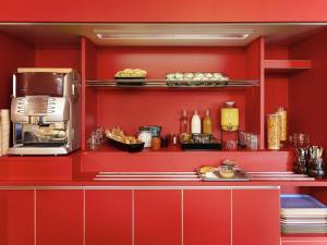 a kitchen with red walls and a counter with food at hotelF1 Metz Actipole in Metz +23 photos