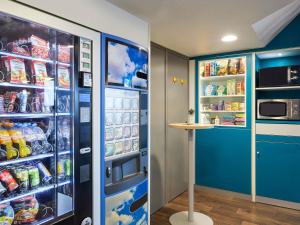 a refrigerator with its door open with food inside at hotelF1 Villepinte Parc des Expositions in Villepinte