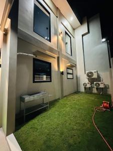 a living room with a large room with green grass at Villa Dietze in Davao City