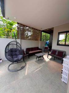 a living room with a chair and a couch at Villa Dietze in Davao City