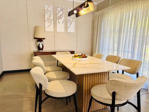 a dining room with a white table and chairs at Homestead in Kempton Park