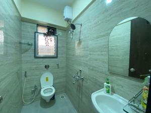 a bathroom with a toilet and a sink at Sheetal Vaibhav 902 in Mumbai +69 photos