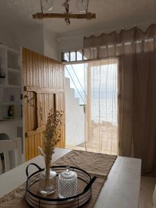 a kitchen with a table with a view of the ocean at Traditional Syrma Nikos in Klima +12 photos