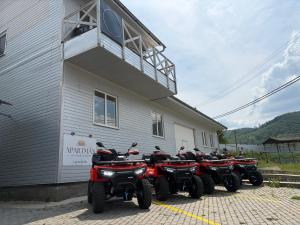 a group of four atvs parked outside of a building at Apartmán Lotos Jasenov Humenné in Humenné