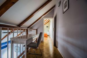 a home office with a desk and a staircase at Ruterra Red Roofs View With Garage in Prague