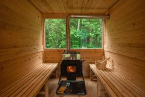a inside of a wooden cabin with a stove in it at Gapyeong Vistahill Pension in Gapyeong