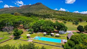 an aerial view of a resort with a swimming pool and a mountain at Blanco Guest Farm - Holiday Resort in Tarkastad