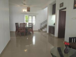 a dining room and living room with a table and chairs at Palm Beach View Resort Cherai in Cherai Beach