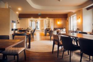 a restaurant with wooden tables and chairs and a dining room at Boutique Hotel Marielle in Bad Münstereifel