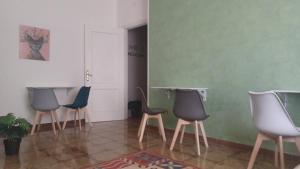 a group of chairs in a room with green walls at B&B home vintage in Marconia