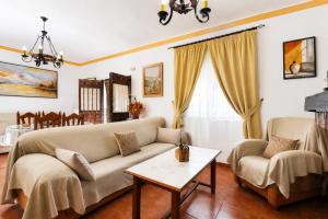 a living room with a couch and a table at Villa Alabarce Nerja by Spain Sun Rentals in Nerja +49 photos