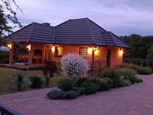 a house with lights on the front of it at Apartman A&E in Živinice