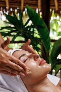 a woman with her hands on her face at Emoyeni Eco Lodge in Sodwana Bay