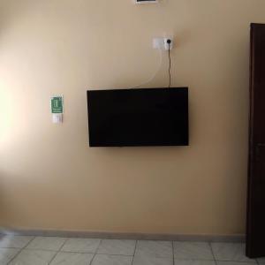 a flat screen tv hanging on a wall at Niki's house 2 in Agia Triada