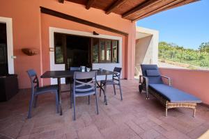 a dining table and chairs on a patio at Casa Cesare - appartamenti a Salina in Isola Salina